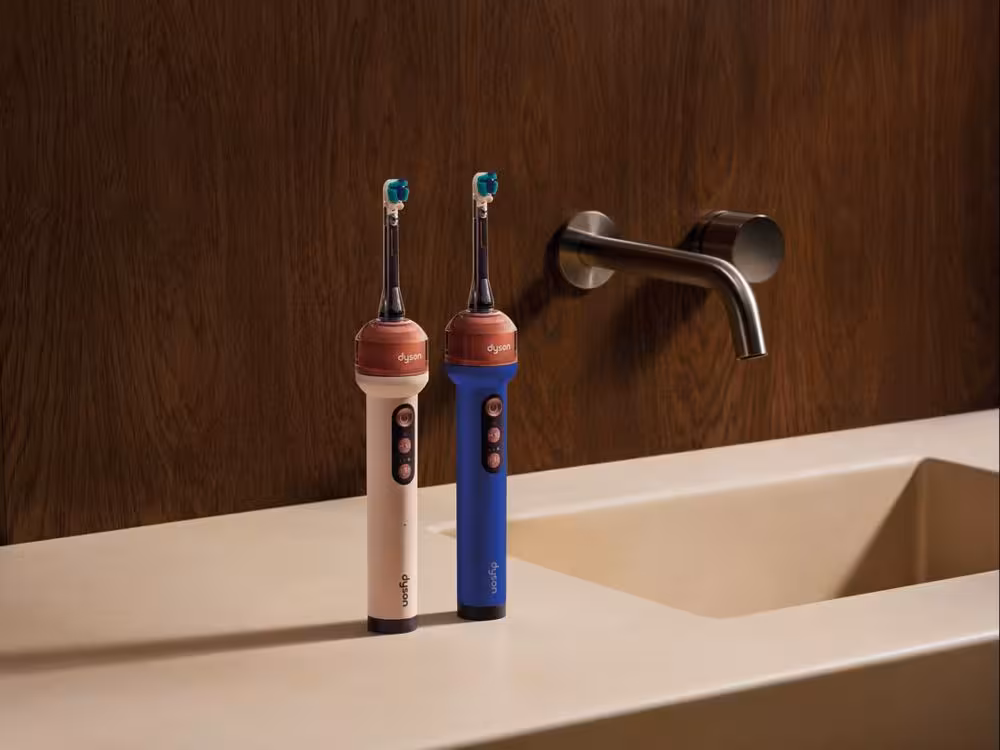 Periuța de dinți electrică Dyson CameraJet în culorile albastru și roz